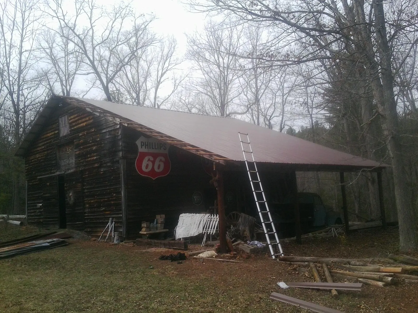 New metal roof on an open sided timber barn with a vintage sign in Springfield